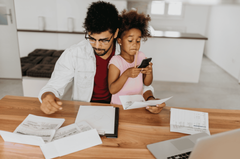 Man at Computer holding daughter